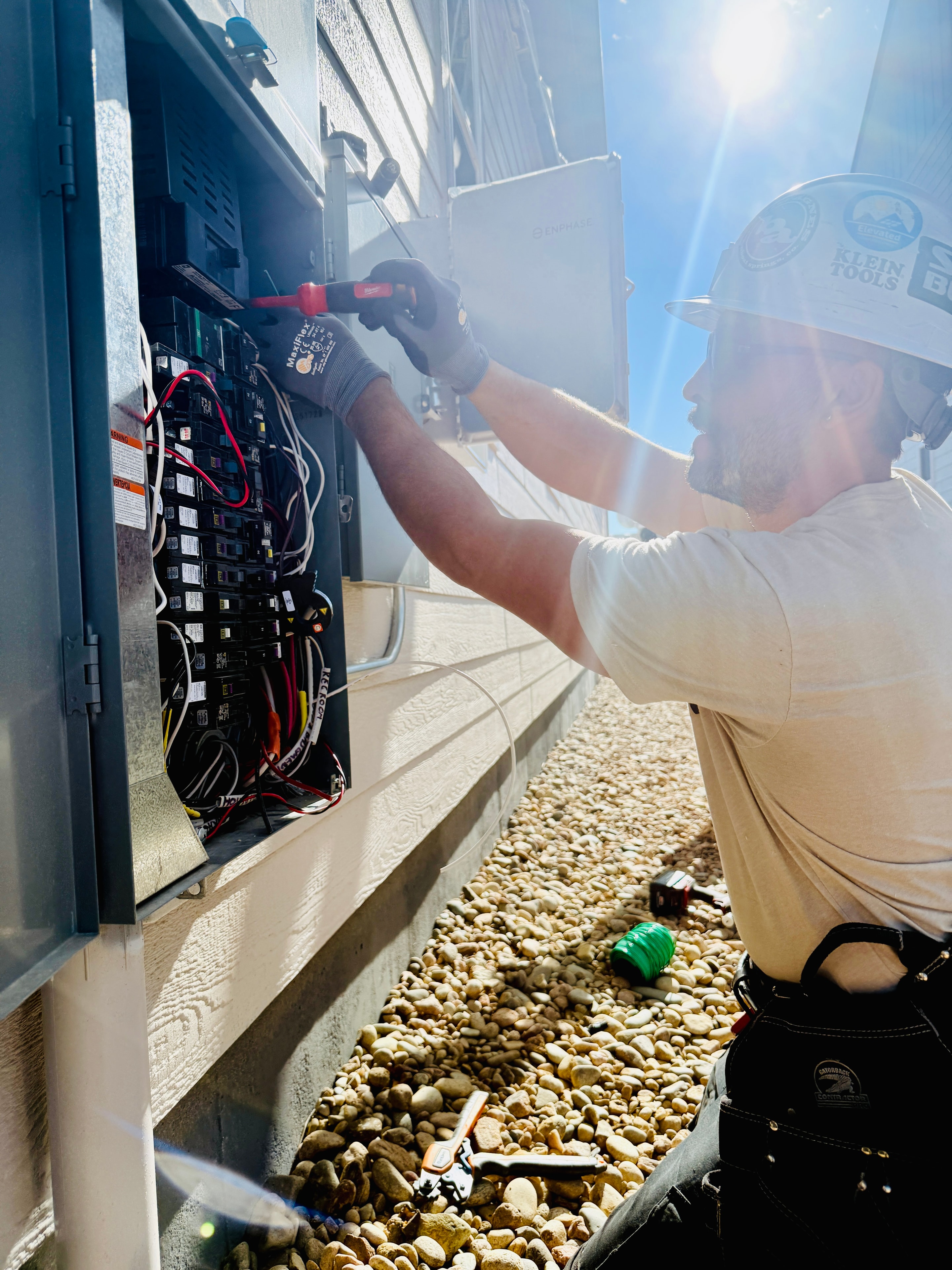 Licensed electrician wiring a solar system electrical panel